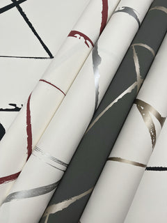 Four rolls of Intersect Wallpaper featuring abstract geometric patterns of metallic and solid-colored intersecting lines.