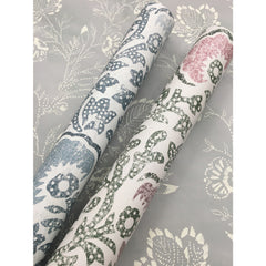 Two rolls of Barbier Wallpaper featuring a blue, green, and pink floral pattern, displayed against a matching gray and white patterned backdrop.