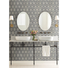 A bathroom vanity with two oval mirrors and vessel sinks set against Candice Olson Everlasting Wallpaper by York Wallcoverings.