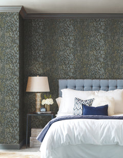A bedroom wall covered in charcoal-colored Candice Olson Gilded Confetti Wallpaper featuring a pattern of scattered metallic rectangles and dots.