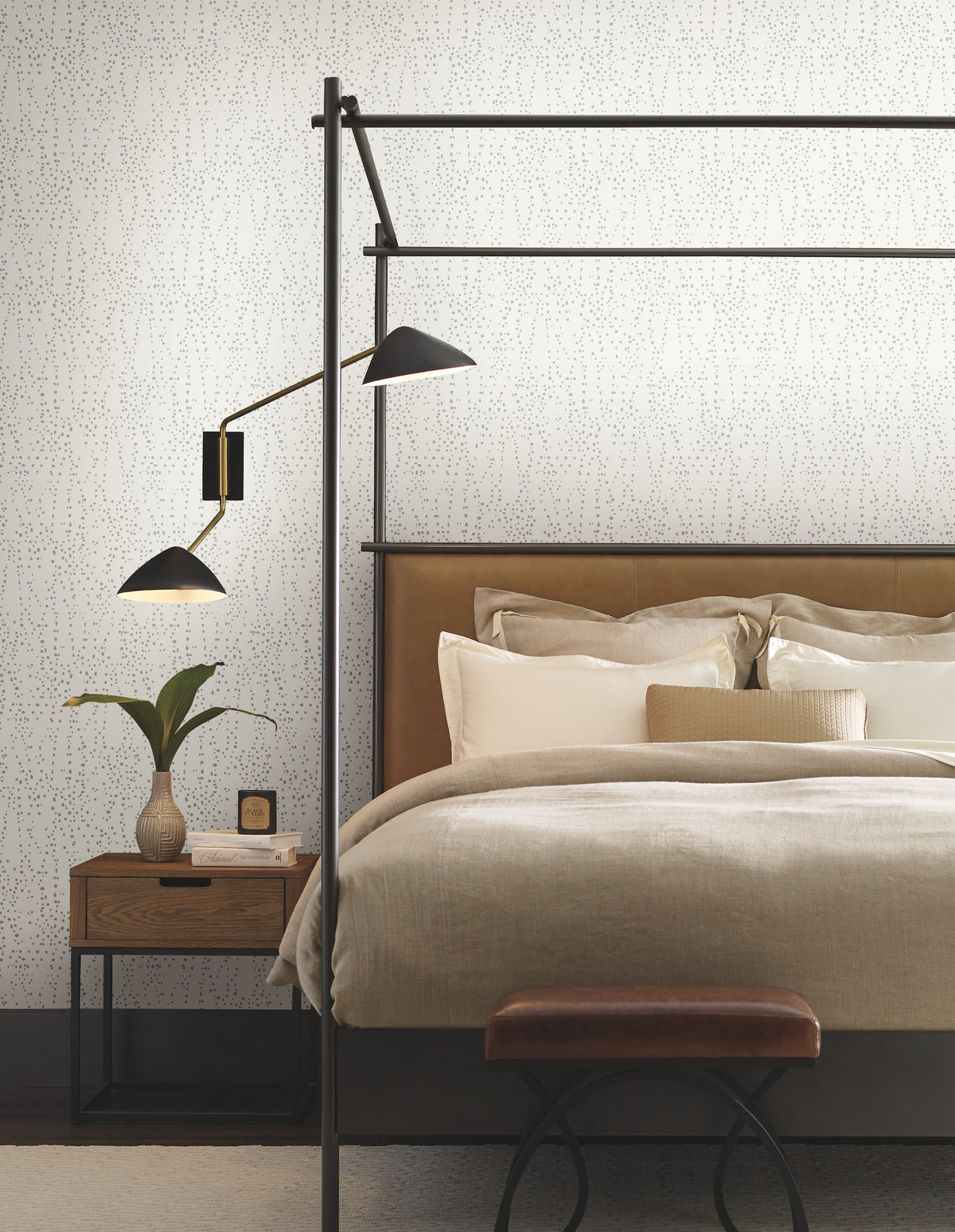 Modern canopy bed set against a wall covered in white Candice Olson Star Struck Wallpaper featuring a subtle pattern of scattered dark gray dots.