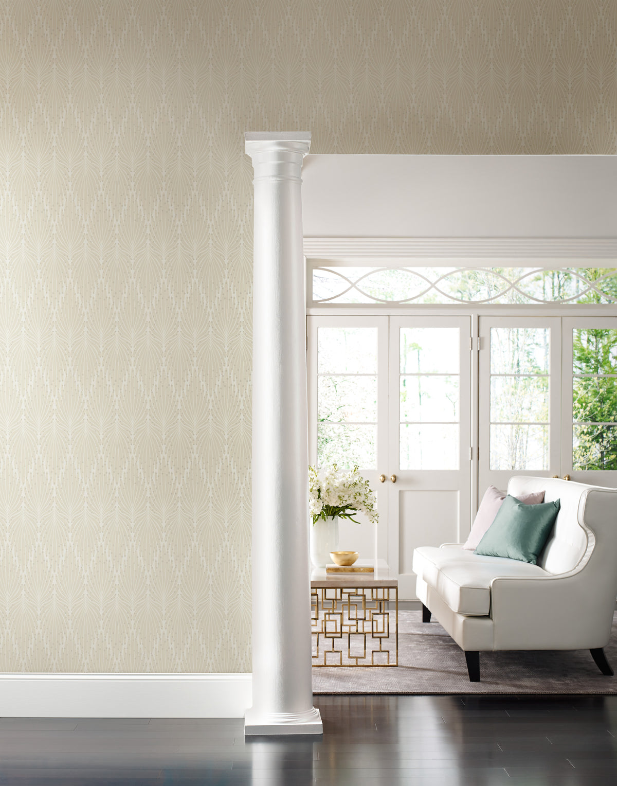 Candice Olson Café Society Wallpaper in light beige with a delicate, white vertical feather pattern covering a wall in a room featuring a white sofa and a column.