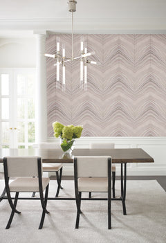 Dining room with a dining table and chairs set against a wall featuring York Wallcoverings Candice Olson Onyx Strata Wallpaper with a light-toned, chevron-like wave pattern.