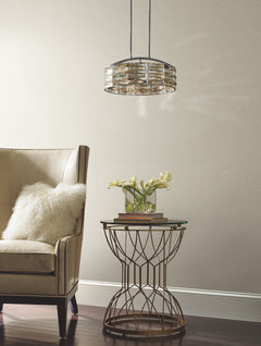 Galaxies Wallpaper with a subtle, small-scale speckled pattern behind a beige armchair and a metal accent table.