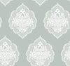 Experience timeless elegance with the Signet Medallion Damask Wallpaper by York Wallcoverings, featuring ornate white floral damask motifs set against a muted sage green background. This wallpaper’s evenly repeating design creates a sophisticated and vintage-inspired ambiance in any room.