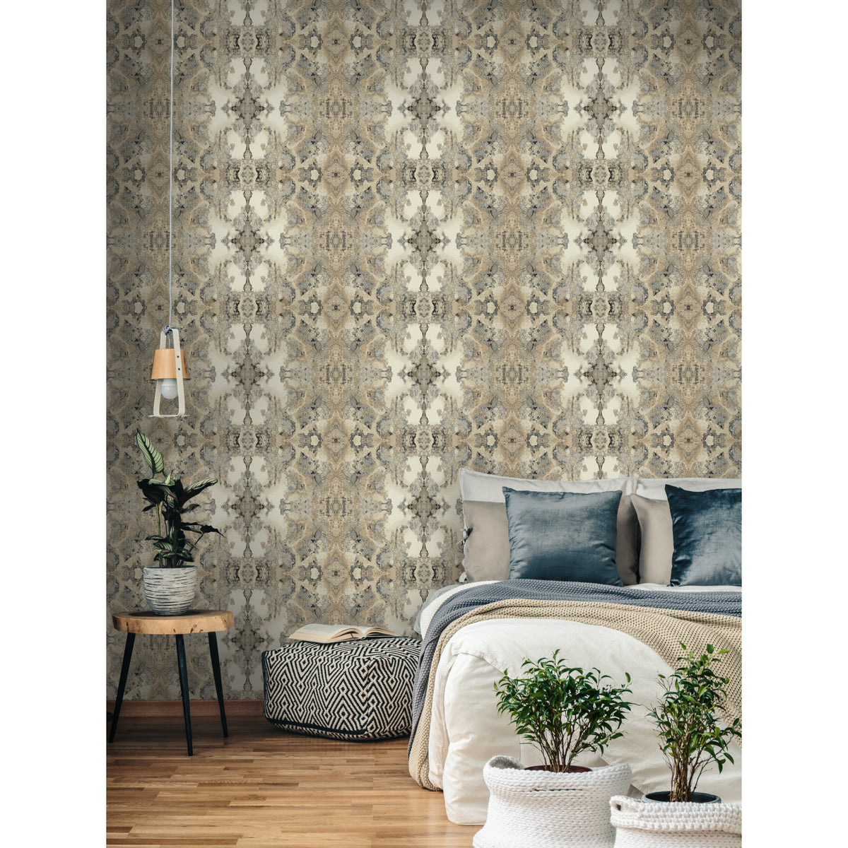 A bedroom wall covered in York Wallcoverings Inner Beauty Wallpaper, featuring a symmetrical, beige and dark grey mottled damask pattern.
