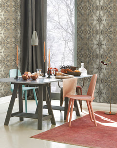 A dining table set for a meal against Inner Beauty Wallpaper by York Wallcoverings, featuring two chairs in different colors, tall candlesticks, and a view of trees through a window.