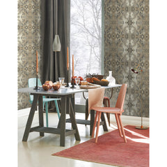 Dining room featuring Inner Beauty Wallpaper by York Wallcoverings, with a gray table set with bowls and candles, and chairs in teal, coral, and dark gray.
