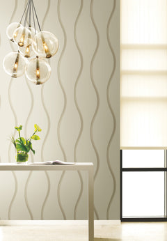 Candice Olson Unfurl Wallpaper by York Wallcoverings featuring a repeating pattern of vertical wavy lines in shades of beige and taupe.