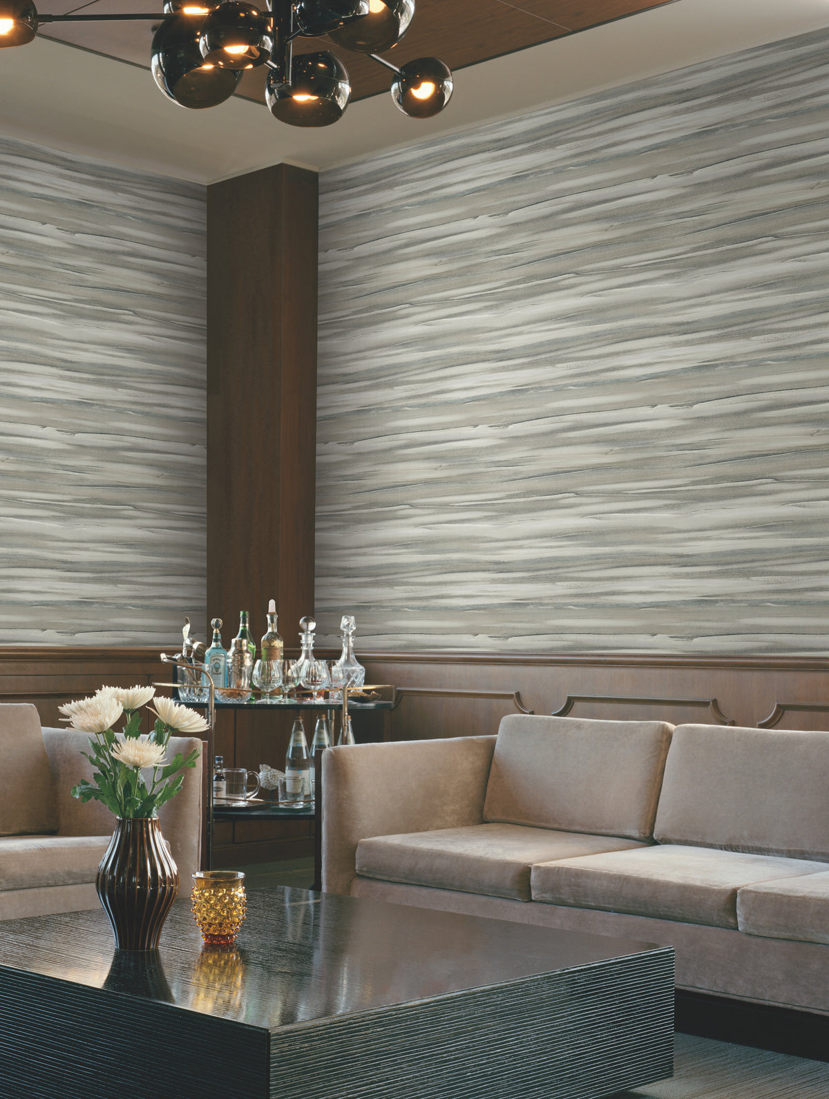 A room featuring Candice Olson Sanctuary Wallpaper with gray and white horizontal wood-grain, brown wainscoting, two sofas, and a coffee table with a vase of flowers.