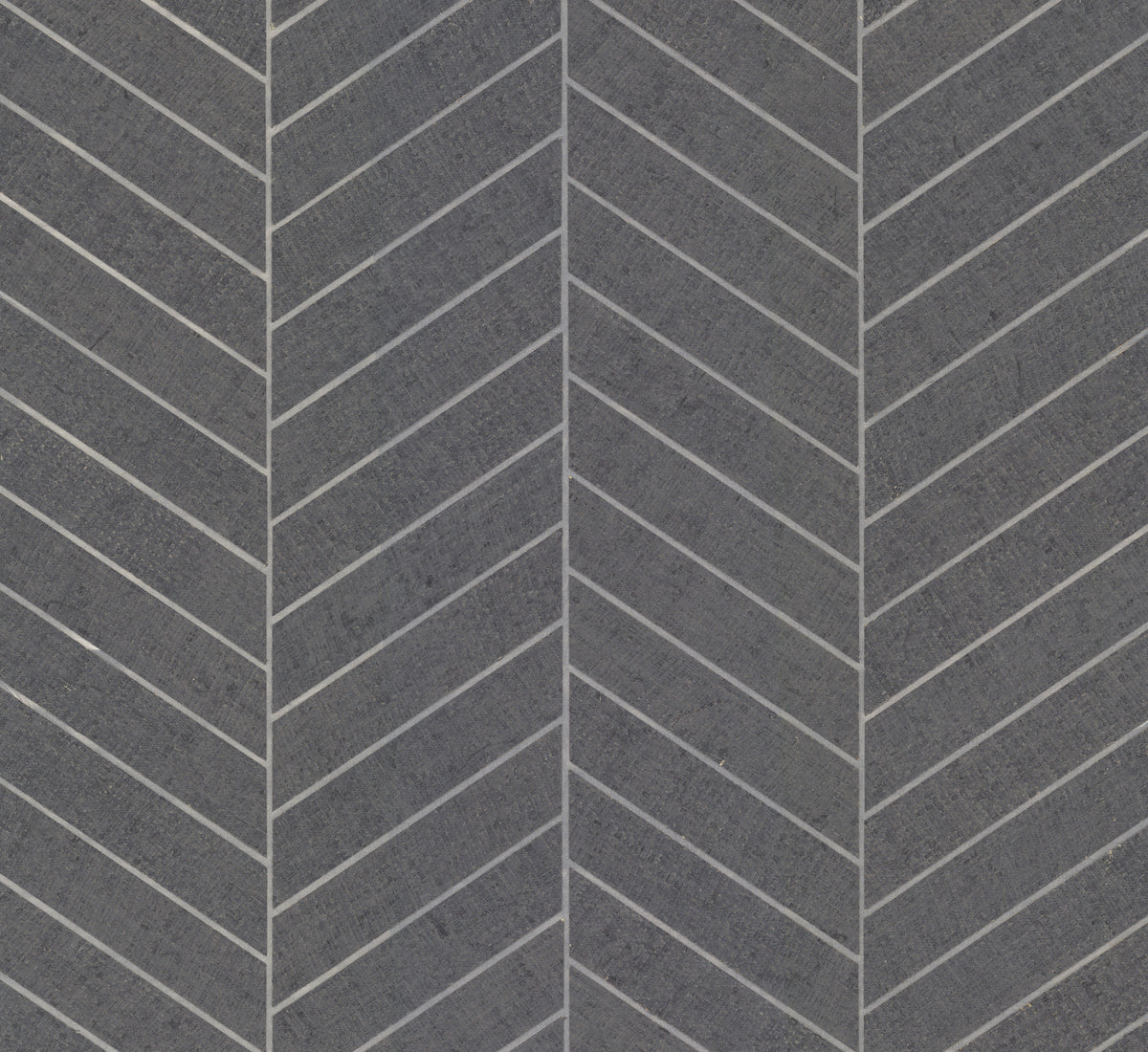 The Ronald Redding Atelier Herringbone Wallpaper by York Wallcoverings features a gray herringbone-patterned surface that mimics rectangular stone tiles, separated by thin white lines, forming a repeating chevron design for a textured and geometric aesthetic.