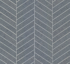 The Ronald Redding Atelier Herringbone Wallpaper by York Wallcoverings features gray concrete-inspired tiles in a chevron pattern, accented with fine white lines along the edges to form a striking, repeating V-shaped geometric design.