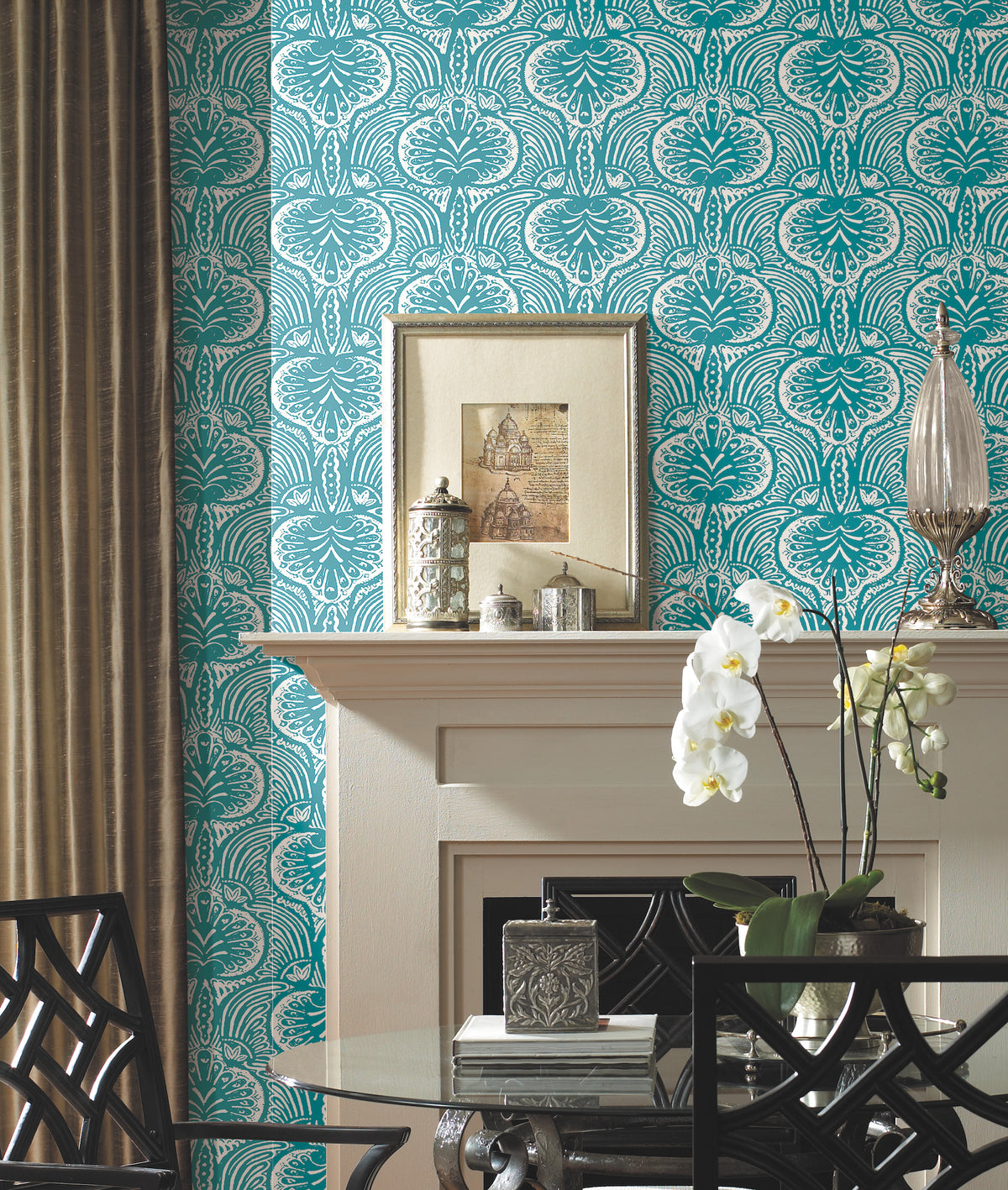 Ronald Redding Lotus Palm Wallpaper in teal and white with a repeating decorative botanical pattern installed behind a fireplace mantel.