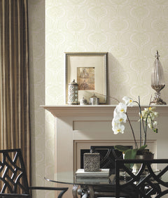 Ronald Redding Lotus Palm Wallpaper by York Wallcoverings with a repeating pale green and white lotus pattern on a wall behind a fireplace mantel.