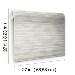 A roll of Ronald Redding Dreamscapes Wallpaper featuring a pattern of horizontal, irregular grey and white stripes, measuring 27 feet by 27 inches.