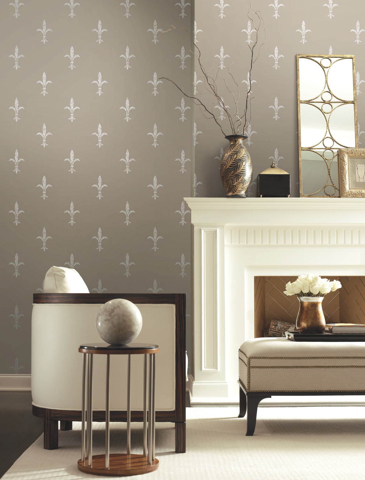 Taupe Ronald Redding Fleur De Lis Wallpaper with a repeating white fleur-de-lis pattern installed in a living room featuring a white fireplace.