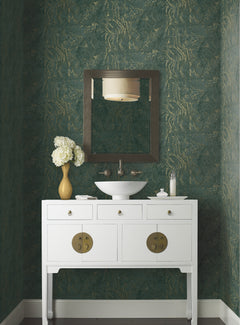 A white bathroom vanity with a bowl sink and a rectangular mirror against a wall covered in green and gold Ronald Redding Polished Marble Wallpaper.