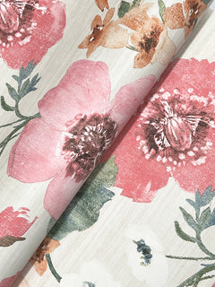A close-up of the Evelyn Floral Wallpaper by York Wallcoverings, featuring an elegant floral pattern with large pink, red, and orange flowers, green leaves, and a soft beige background. The wallpaper is shown slightly curved in the middle.