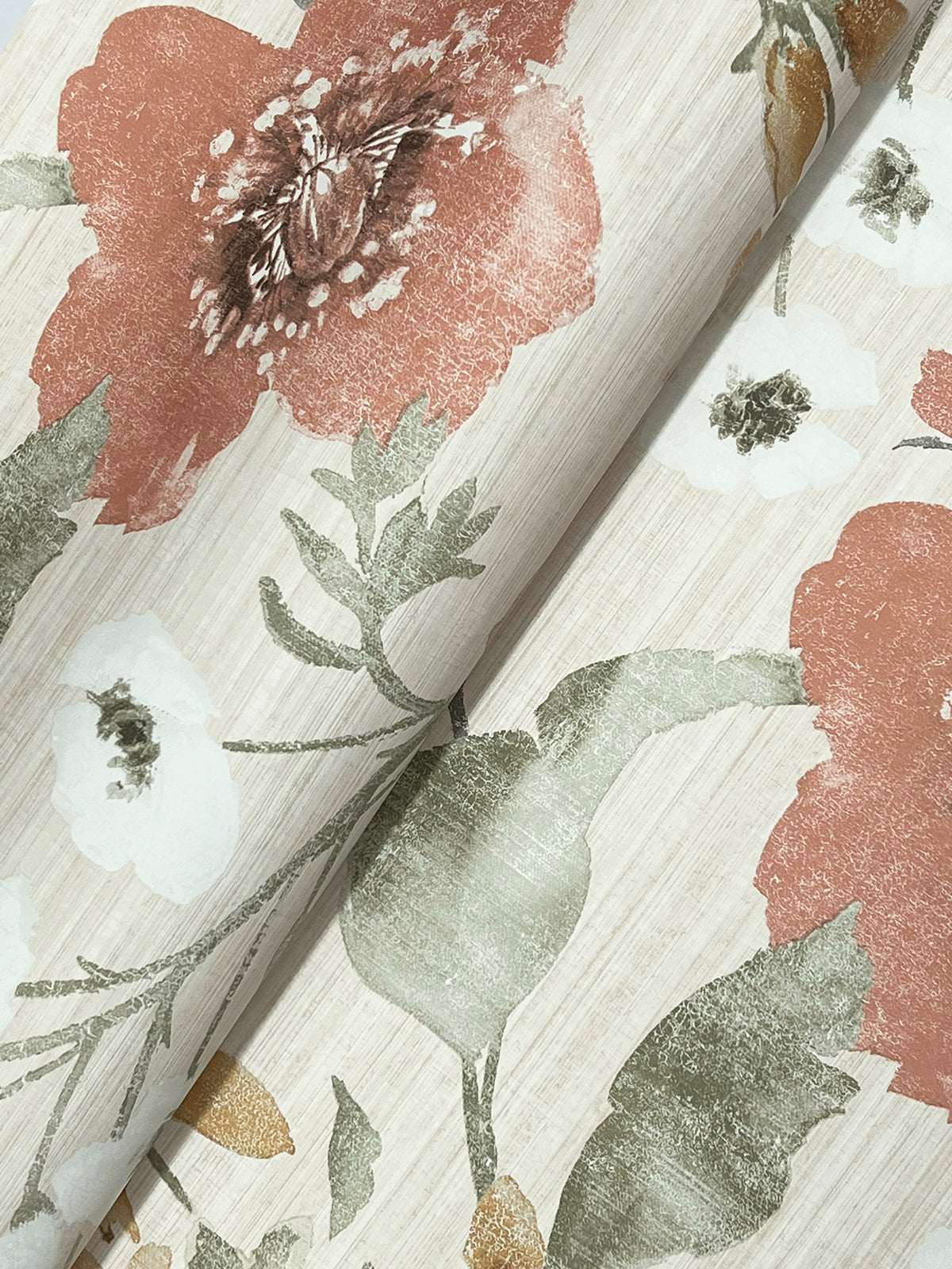 A close-up of the Evelyn Floral Wallpaper by York Wallcoverings, featuring large red and white flowers with green leaves on a light beige background.