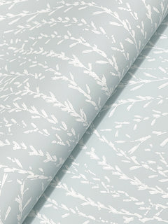 Close-up of Willow Song Botanical Wallpaper by York Wallcoverings, featuring a light blue background with a delicate white abstract pattern inspired by nature, resembling branches or leaves for a textured look.