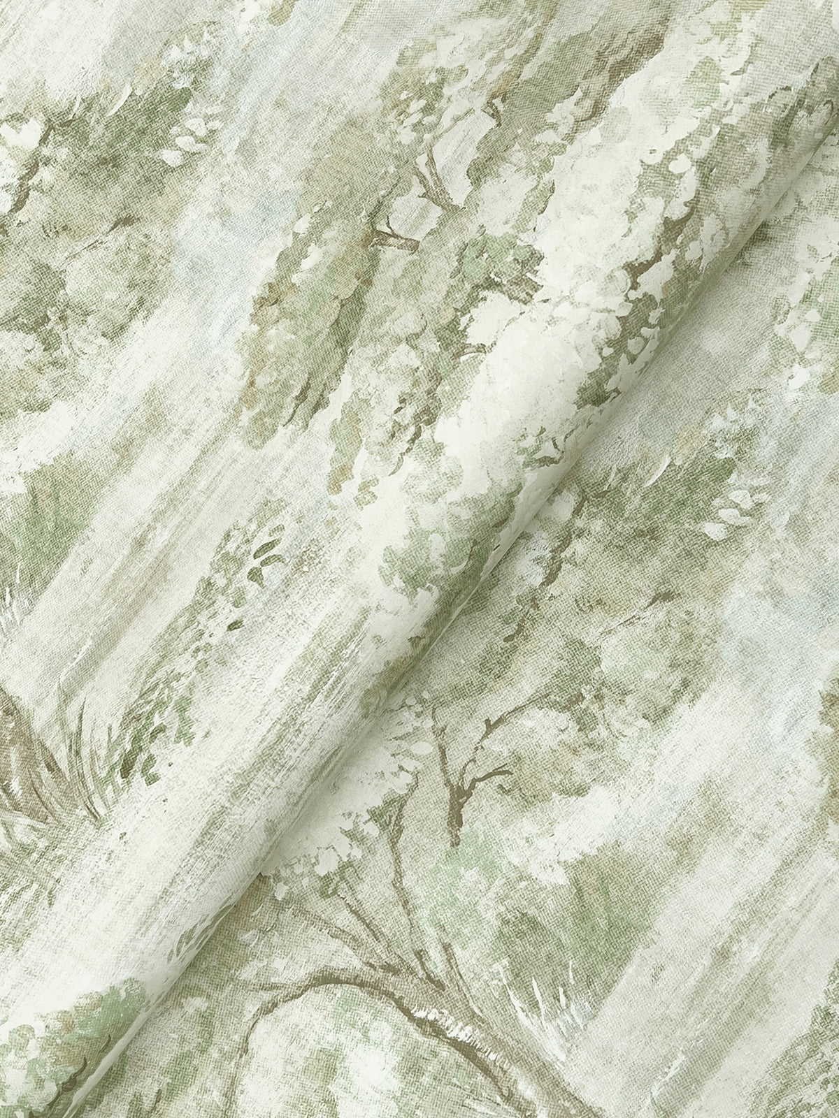 A close-up of the Moreno Woodland Wallpaper by York Wallcoverings, showcasing a watercolor-style green and beige landscape print with trees and foliage that creates a soft, serene, and airy pattern.