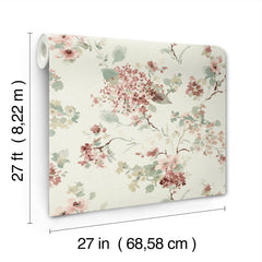 The Veiled Garden Floral Wallpaper by York Wallcoverings features a floral pattern with pink, green, and beige flowers. Each roll measures 27 feet (8.22 m) in length and 27 inches (68.58 cm) in width.