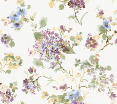 Veiled Garden Floral Wallpaper by York Wallcoverings features a watercolor-style floral pattern with clusters of purple, blue, and yellow flowers and green leaves scattered across a white background.
