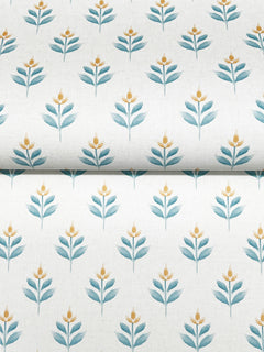York Wallcoverings’ Serene Villa Floral Stamp Wallpaper features a repeating pattern of stylized blue-green leaves and small yellow flowers, arranged in evenly spaced rows on a light background.