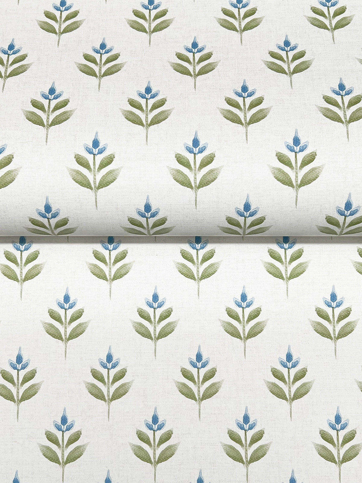 Serene Villa Floral Stamp Wallpaper by York Wallcoverings features an orderly, symmetrical pattern of stylized green stems and leaves, each topped with small blue flowers, all set against a clean white background for a fresh botanical look.