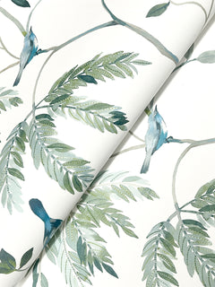 Cillian Botanical Bird Trail Wallpaper by York Wallcoverings features a watercolor-style illustration of blue birds perched on leafy green branches, printed on a lightly folded white sheet.