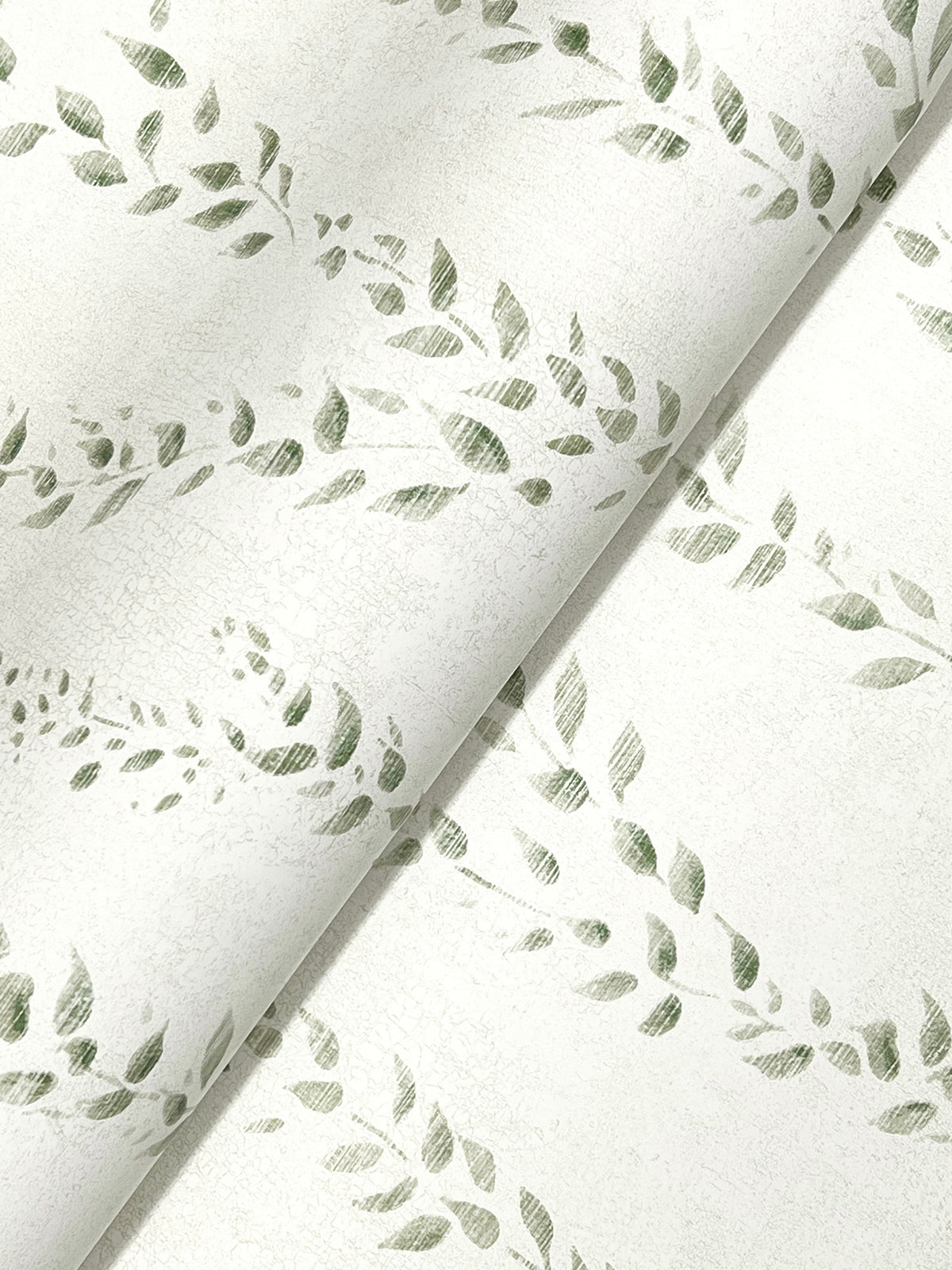 Close-up of light-colored, textured Alpenrose Vine Wallpaper by York Wallcoverings, featuring a repeating pattern of green leaves on vines. The wallpaper is slightly folded, creating a gentle diagonal crease across the image.