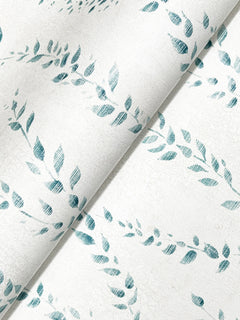 A diagonally folded sheet of Alpenrose Vine Wallpaper by York Wallcoverings, featuring a blue leaf wreath pattern on white with a subtle crackled background texture.