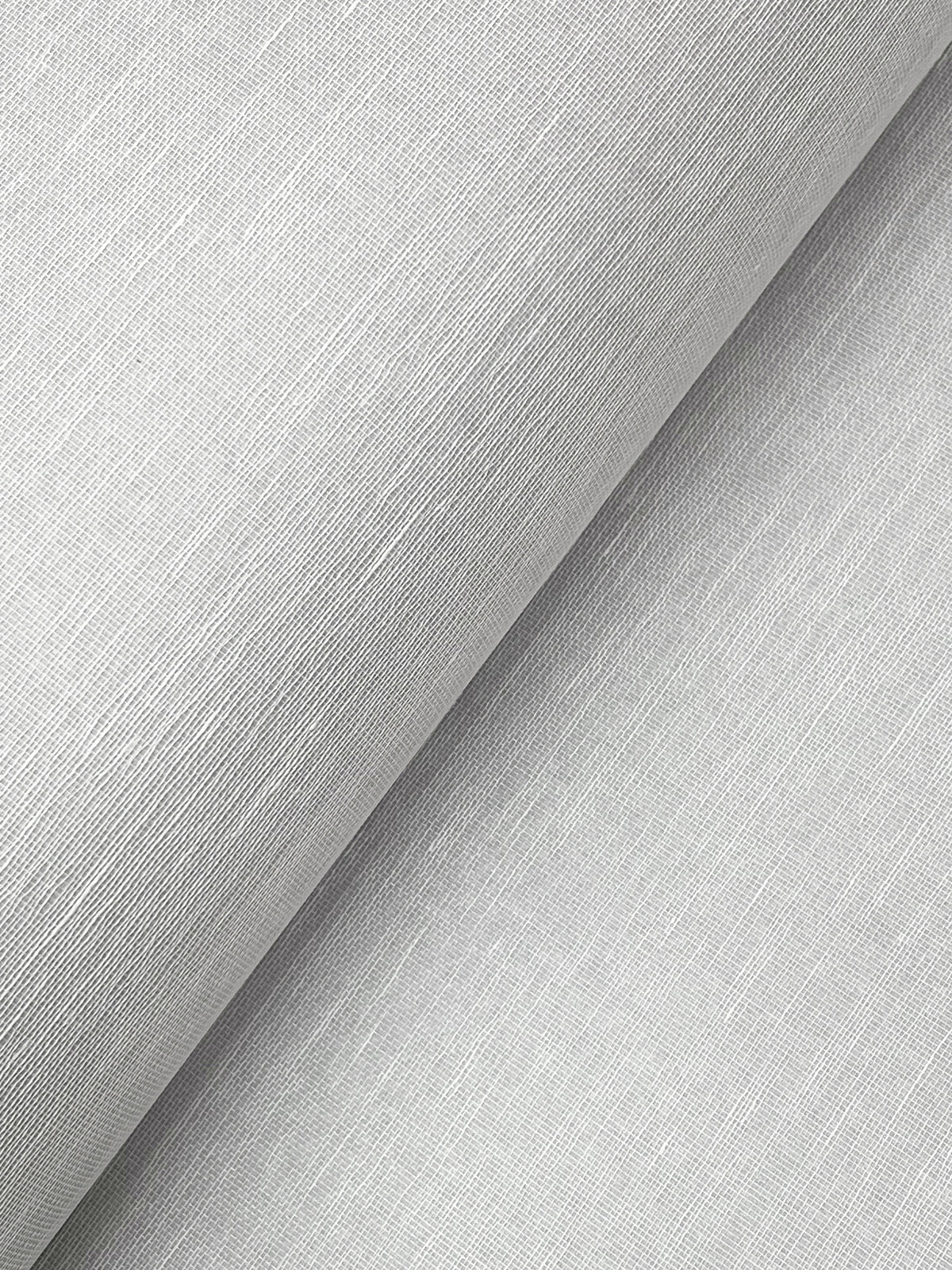 Close-up of York Wallcoverings’ Hempfield Weave Loomed Wallpaper in light gray, featuring a finely textured surface with subtle diagonal lines that create a soft, smooth appearance. The image highlights the wallpaper’s distinctive weave and slight sheen under the light.
