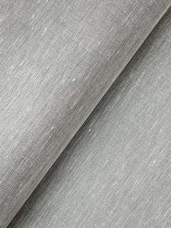 Close-up view of York Wallcoverings’ Hempfield Weave Loomed Wallpaper in light gray, showcasing its subtle texture and woven pattern. The wallpaper appears partially folded diagonally, accentuating the fine, natural fibers and gentle irregularities that add to its authentic look.