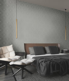 Modern bedroom featuring Harlowe Wallpaper by York Wallcoverings in a gray geometric pattern, a brown leather headboard, gray bedding, a cream sofa, two round ottomans, two hanging cylindrical gold lights, and dark wood flooring.