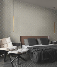 A modern bedroom featuring Harlowe Wallpaper by York Wallcoverings, a brown and white bed with gray pillows, a cream sofa, two footstools, and two slim gold pendant lights hanging from the ceiling.