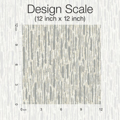 A 12x12 inch square featuring the Metallic Cascade Wallpaper by York Wallcoverings is centered on a matching background, displaying a beige and gray abstract vertical stripe pattern. “Design Scale (12 inch x 12 inch)” is written above, and horizontal and vertical inch rulers frame the square.