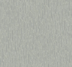 Metallic Cascade Wallpaper by York Wallcoverings features a light blue and gray abstract pattern with vertical streaks and textured, uneven lines that evoke the look of a painted or brushed surface. The repetitive, uniform design extends seamlessly across the entire wallpaper.