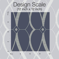 Here’s a rewritten version using the provided product data: The Graceful Geo Wallpaper by York Wallcoverings features a 12-inch by 12-inch square sample with curving lines and diamond shapes set against a dark blue background. Inch markers run along the left and bottom edges as a scale, with “Design Scale” labeled above.