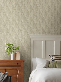 Magnolia Home Challenger Wallpaper with a neutral, textured chevron pattern behind a bedroom scene with a wooden nightstand and white bed.