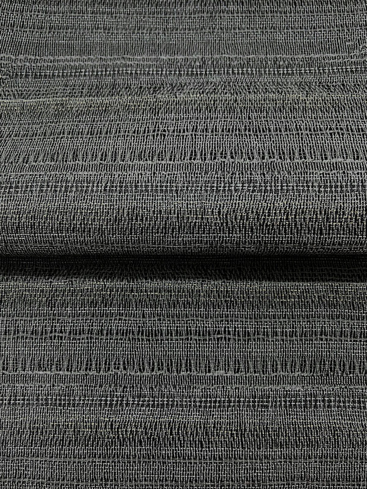 Magnolia Home In The Details Wallpaper in dark gray with a textured, woven fabric appearance.