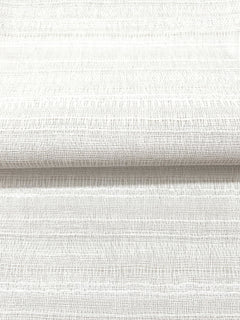 A close-up view of Magnolia Home In The Details Wallpaper, featuring textured off-white wallpaper with a subtle horizontal crosshatch pattern.
