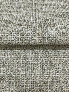 Folded sheet of Magnolia Home Brindled Wallpaper featuring a mottled, grid-like pattern in shades of brown and off-white.