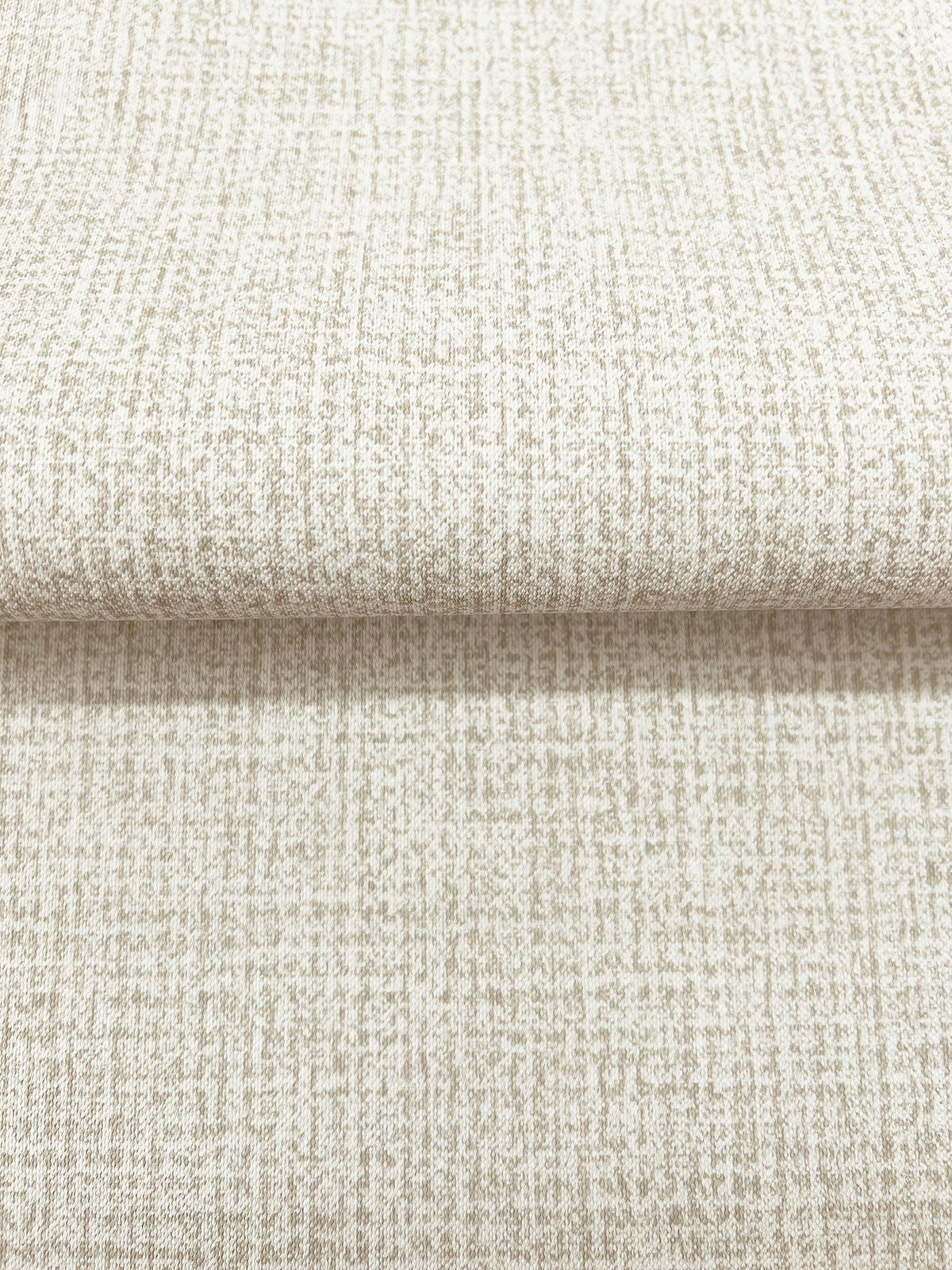 Magnolia Home Brindled Wallpaper featuring a neutral, textured pattern with a grid-like arrangement of small, light brown flecks on an off-white background.