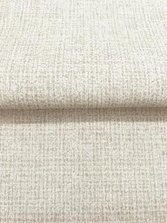 Magnolia Home Brindled Wallpaper featuring a neutral, textured pattern with a grid-like arrangement of small, light brown flecks on an off-white background.