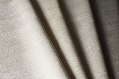 On Deck Wallpaper in beige with a subtle, fine-lined crosshatch texture, shown in folded overlapping sections.
