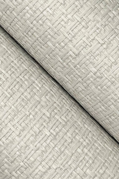Close-up of two layers of York Wallcoverings’ Ronald Redding Tatami Weave Wallpaper in beige, featuring a textured basket-weave pattern, arranged diagonally and overlapping each other.