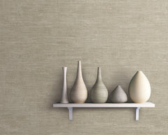 A white shelf holds five decorative vases of varying shapes and neutral tones, displayed against a Heathered Wool Wallpaper by York Wallcoverings in textured beige.