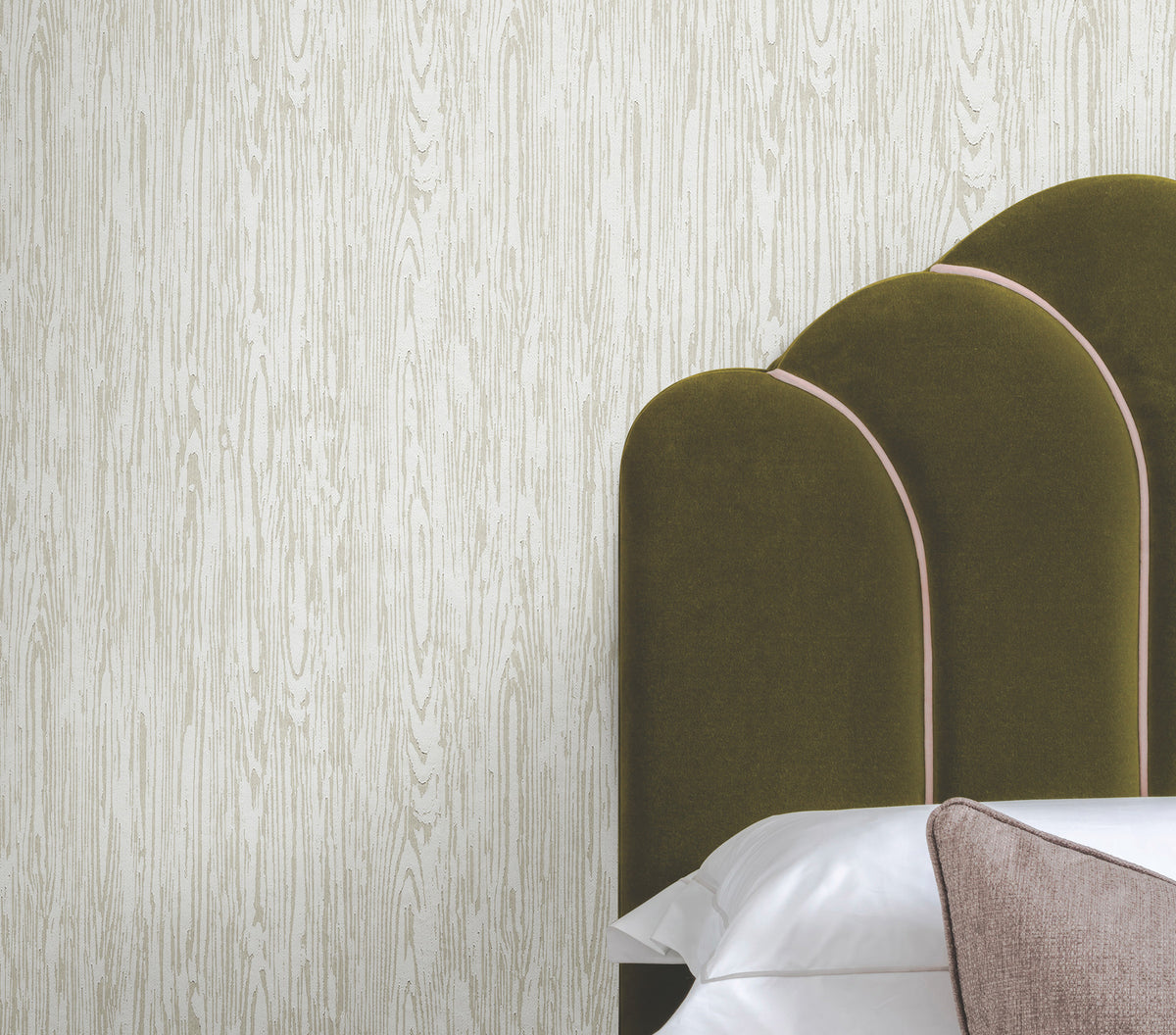 Ronald Redding Heartwood Wallpaper featuring a white and light grey vertical wood grain pattern behind a dark olive green upholstered headboard.