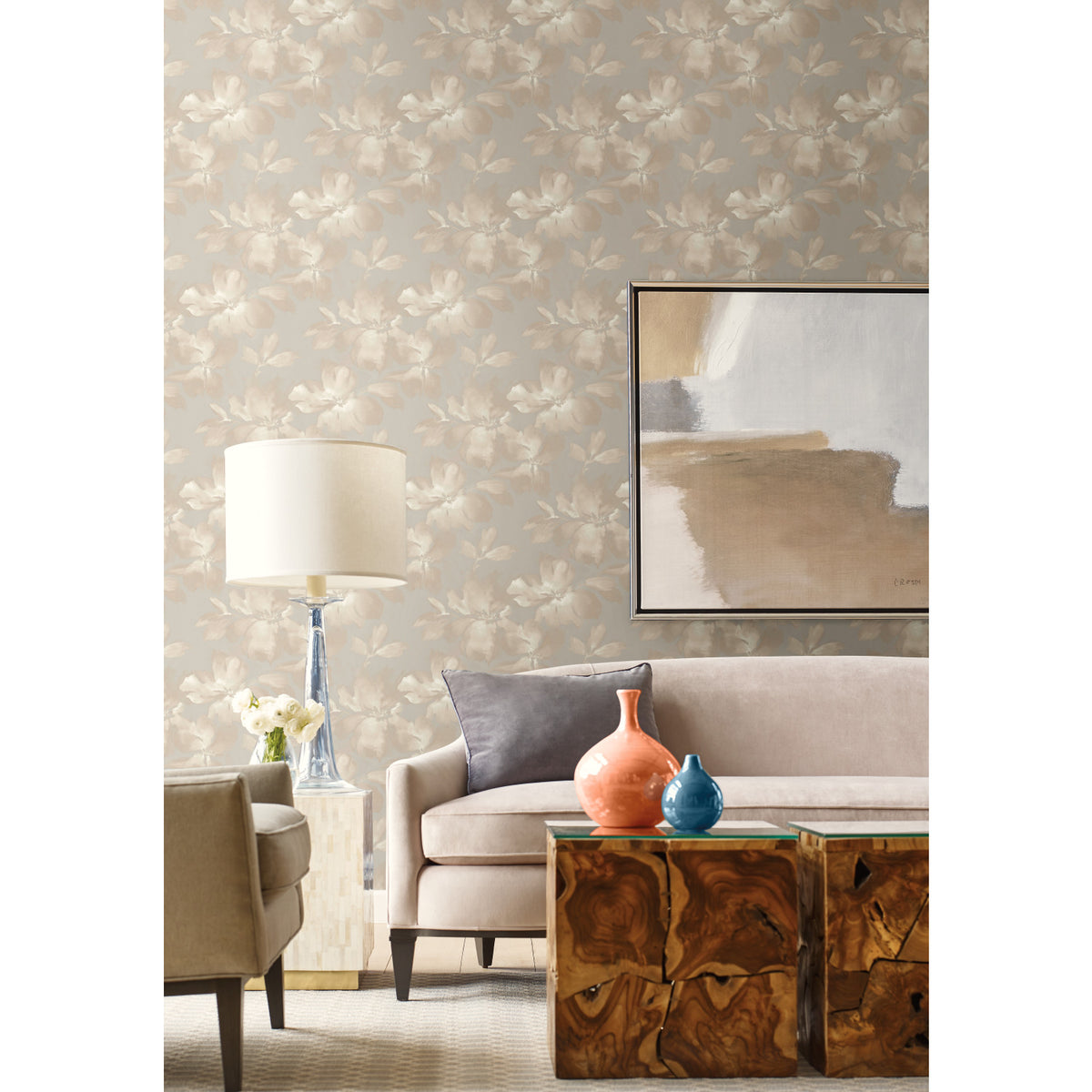 A living room featuring Midnight Blooms Wallpaper with a beige floral pattern, a neutral sofa, two wooden side tables, and abstract wall art.